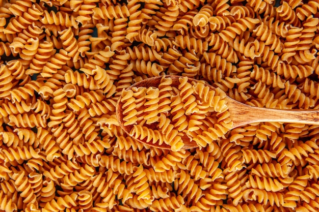 Above view of raw italian pastas and wooden spoon high resolution footage
