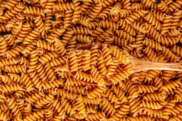 Above view of raw Italian pastas and wooden spoon high resolution footage