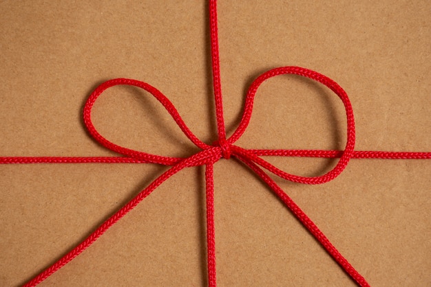 View of red thread with knot and bow