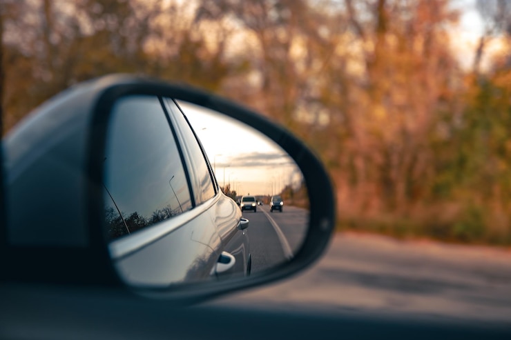 Free Photo the view of the road in the cars rearview mirror