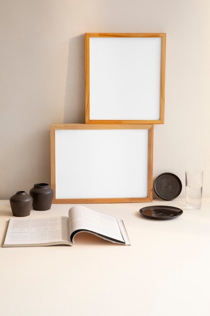 View of room decor made up of frames and magazine with vases