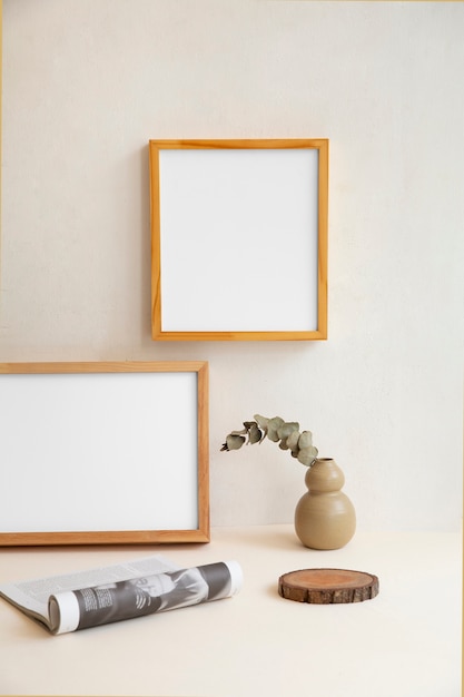 View of room decor made up of frames and plant vase with magazine