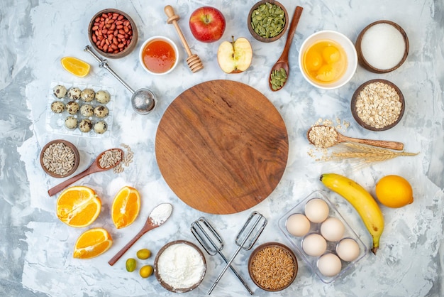 Above view of round board and ingredients for the healthy foods selection on ice background