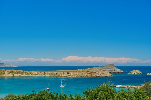 View of sailboats in the bay near the ancient city of Lindos on the Greek island of Rhodes view of the Aegean Sea the islands of the Dodecanese archipelago Europe