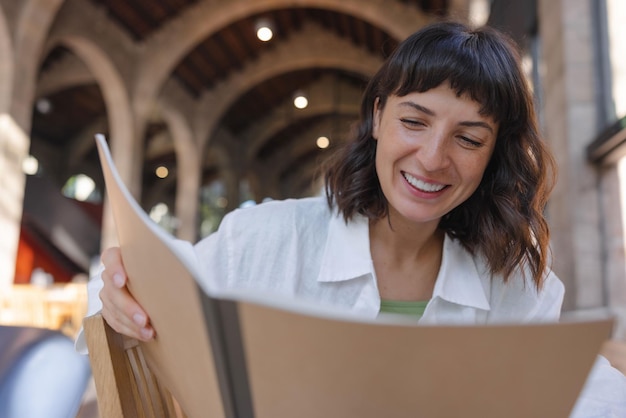 Free photo view of smiles woman looking at notebook