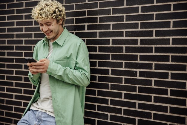 View of smiling man holding smartphone