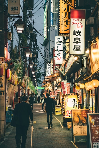 View of a street in the city and night with lights and people