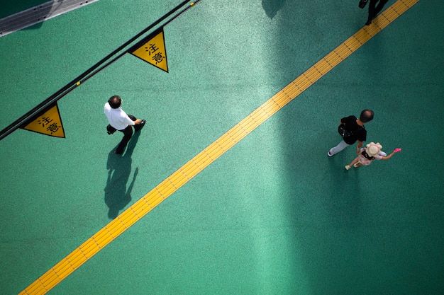 Free photo view of street with daylight shadows and people