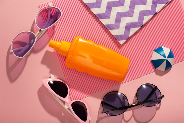 View of sunglasses with summer essentials and watermelon bag