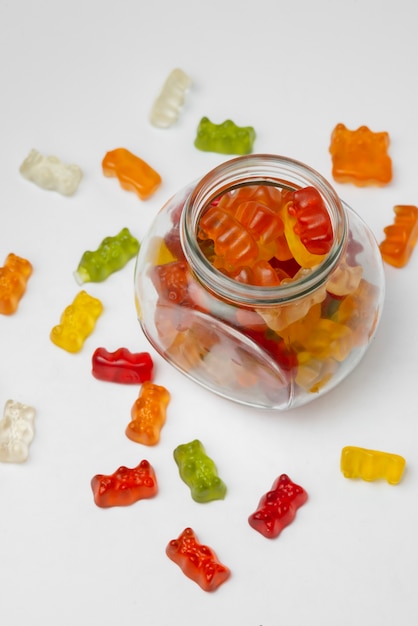 View of sweet gummy bears with glass jar