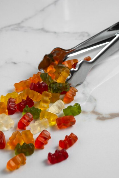 Free photo view of sweet gummy bears with spoon