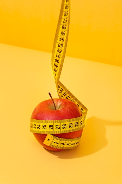 View of tape measure with apple fruit