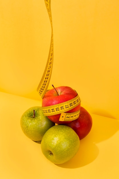 Free photo view of tape measure with apple fruit