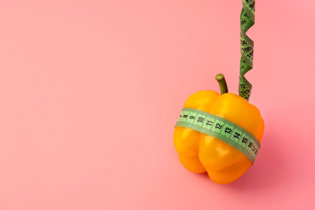 Free photo view of tape measure with bell pepper