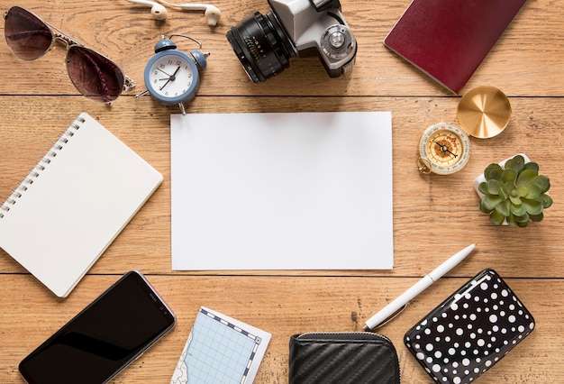 Free photo above view traveling items on wooden background