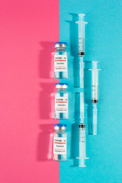 Above view vaccine vials and syringes