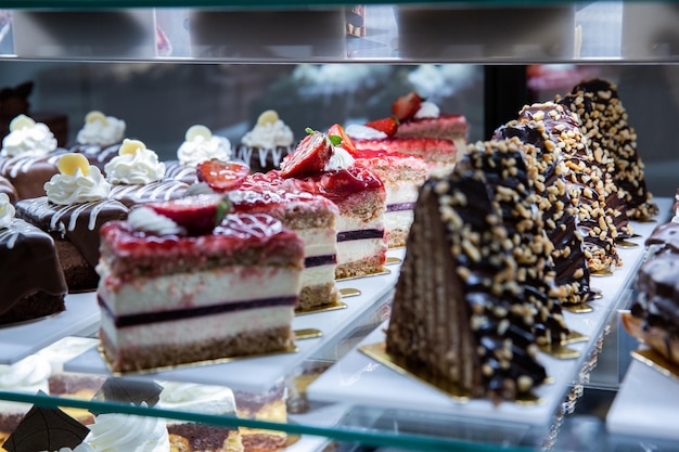 View of various assortment of cakes on the stand in the bakery