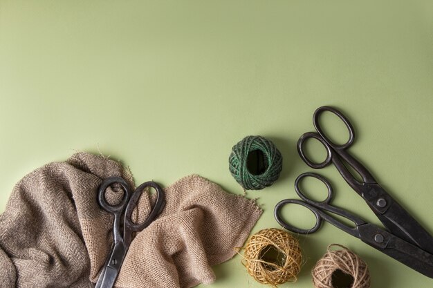 View of vintage scissors with string and material