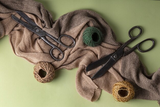 View of vintage scissors with string and material