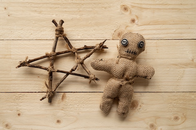 Free photo above view voodoo doll on wooden background