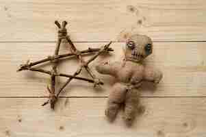 Free photo above view voodoo doll on wooden background