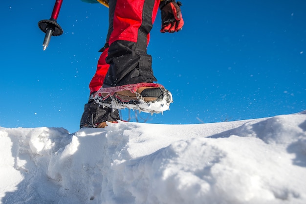 Free photo view of walking on snow with snow shoes and shoe spikes in winter