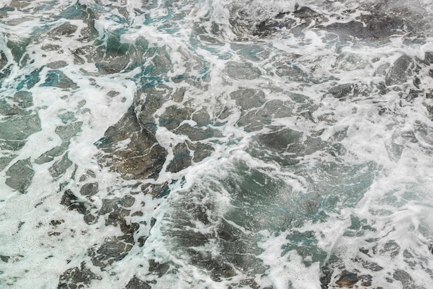 Above view waves at rocky shore