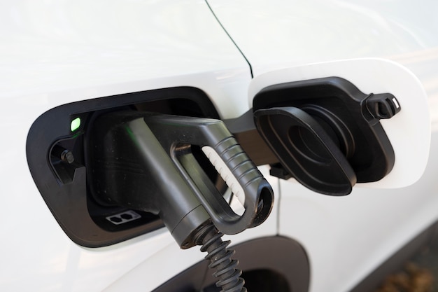 Free photo view of white electric car charging at a station