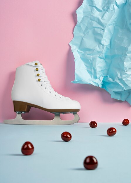 View of white ice skates with cherries