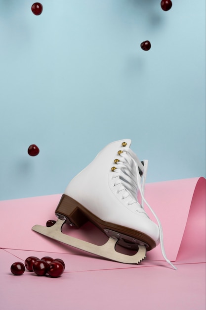 Free photo view of white ice skates with cherries