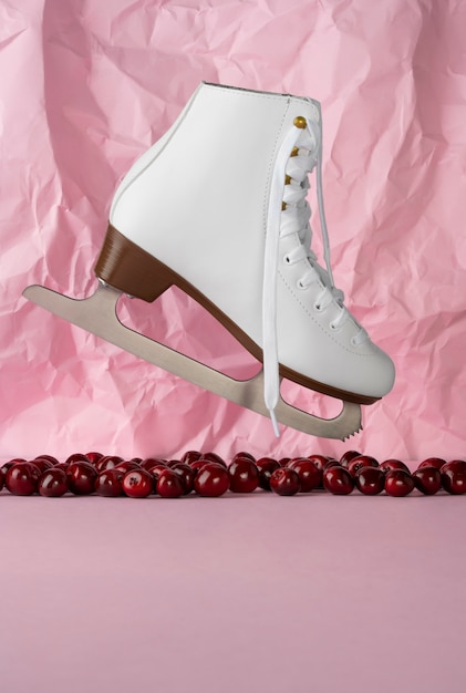 View of white ice skates with cherries