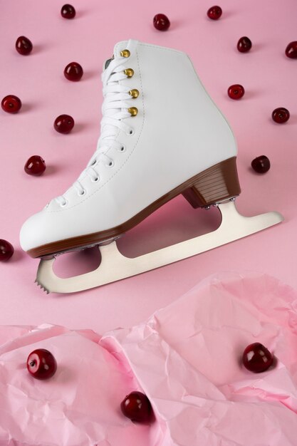 View of white ice skates with cherries