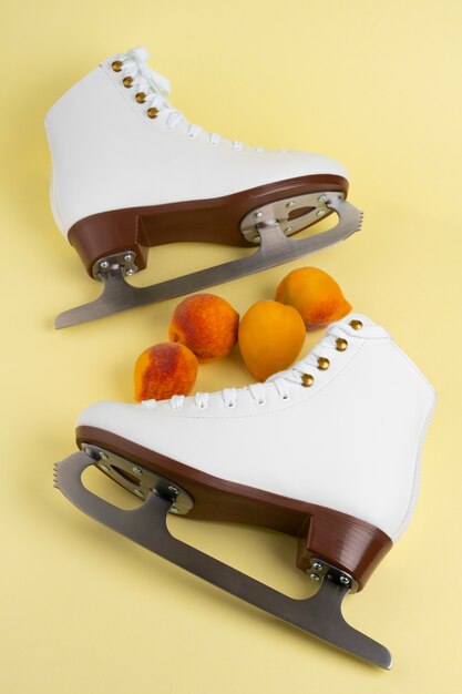 View of white ice skates with peaches