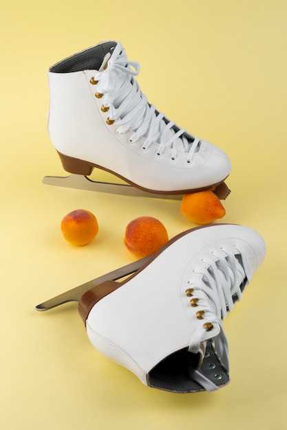 Free photo view of white ice skates with peaches