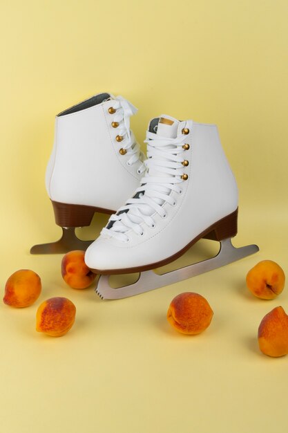 Free photo view of white ice skates with peaches