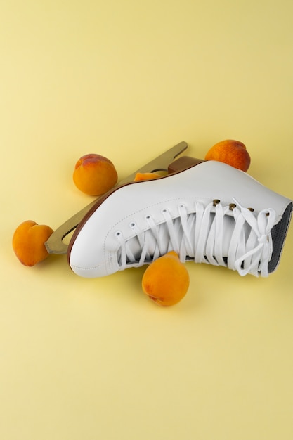 Free photo view of white ice skates with peaches