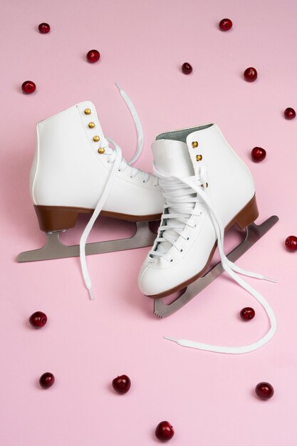 View of white ice skates with raspberries