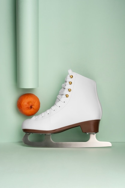 Free photo view of white ice skates with tangerines