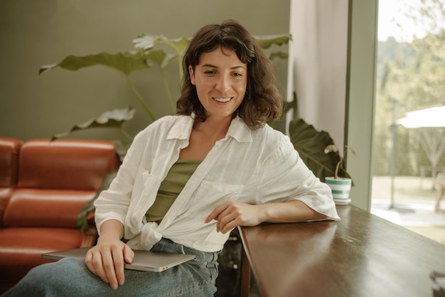 Free photo view of woman in cafe with laptop