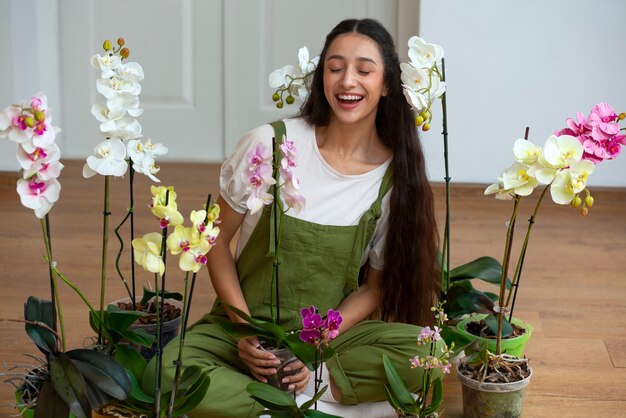 View of woman decorating her home with orchid flower