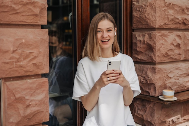 Free photo view of woman luffing at camera with phone