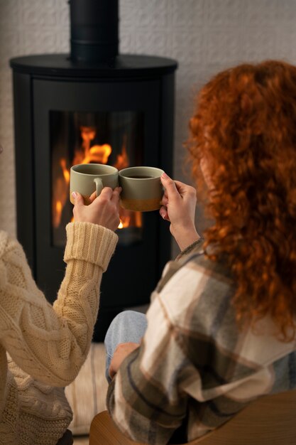 View of woman relaxing at home with a warm drink