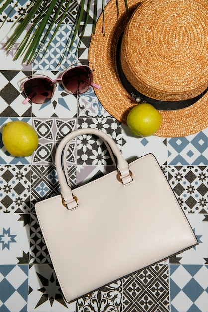 Free photo view of women's bag with mediterranean tiles aesthetics