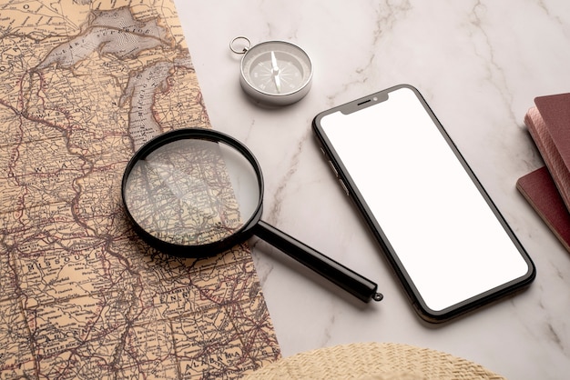 View of world travel map with smartphone and magnifying glass