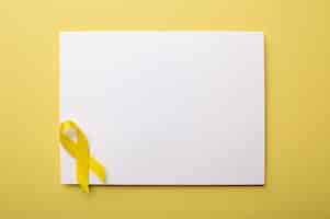 Free photo view of yellow ribbon with paper