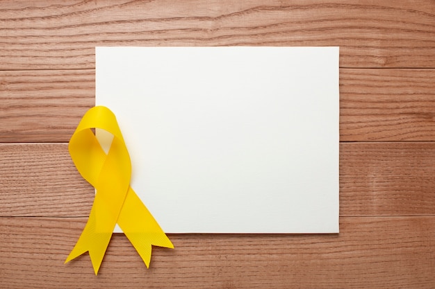 Free photo view of yellow ribbon on wooden background