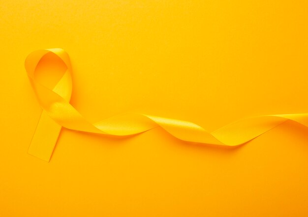 View of yellow ribbon on yellow background