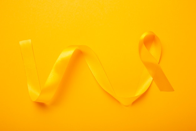 View of yellow ribbon on yellow background