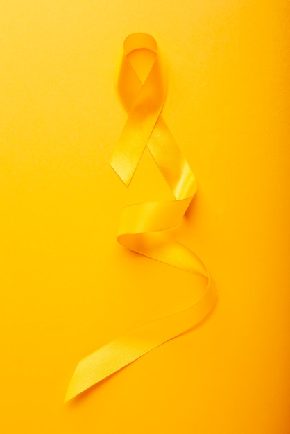 View of yellow ribbon on yellow background