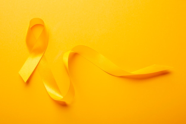 View of yellow ribbon on yellow background